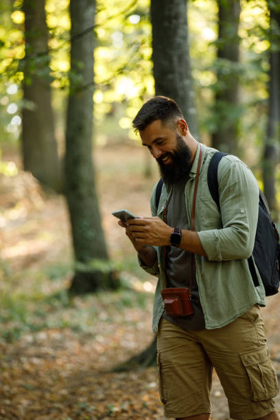 istock Happy young man enjoying a relaxing hike through the forest 1436783845