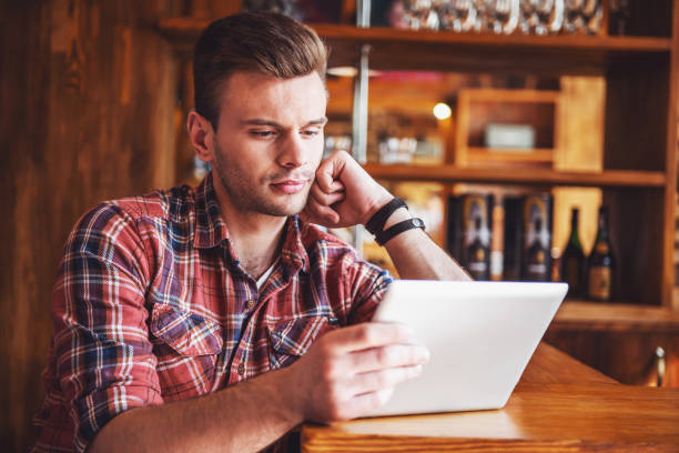 istock Young man with gadget at cafe 1436786461