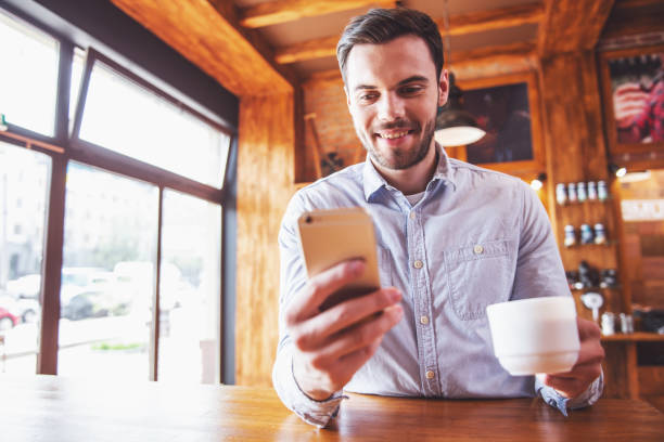 istock Young businessman with gadget at cafe 1436786715