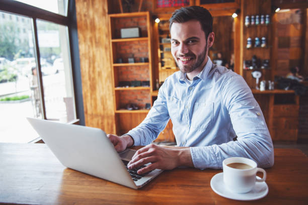 istock Young businessman with gadget at cafe 1436786719
