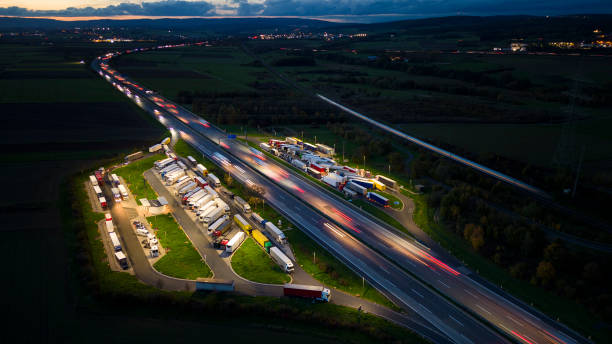 istock Highway and rest area at dusk - aerial view 1436788035