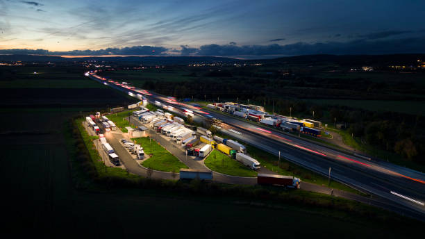 istock Highway and rest area at dusk - aerial view 1436788045