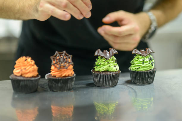 istock pastry chef baker preparing halloween green orange monster cupcakes handmade 1436788446
