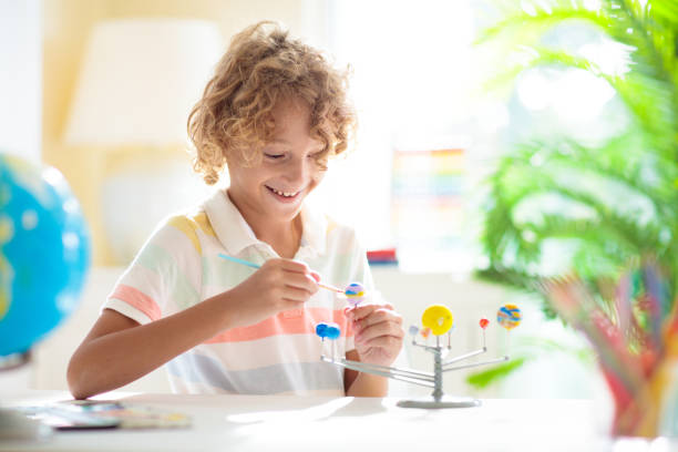 istock Child with solar system model. Kids planetarium. 1436792200