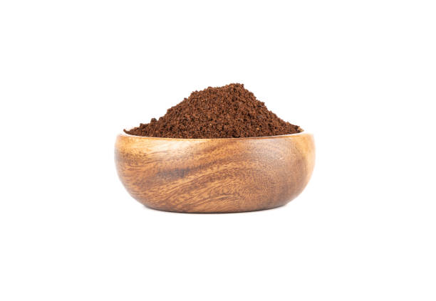 istock Ground coffee in a wooden bowl isolated on a white background. 1436794045