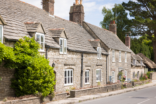 Row of old stone cottages, terraced houses in Corfe Castle Village, Dorset