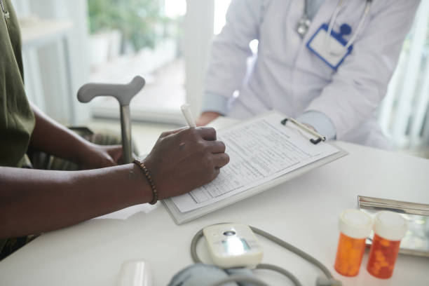 istock Patient Filling Health Insurance Form 1436796749