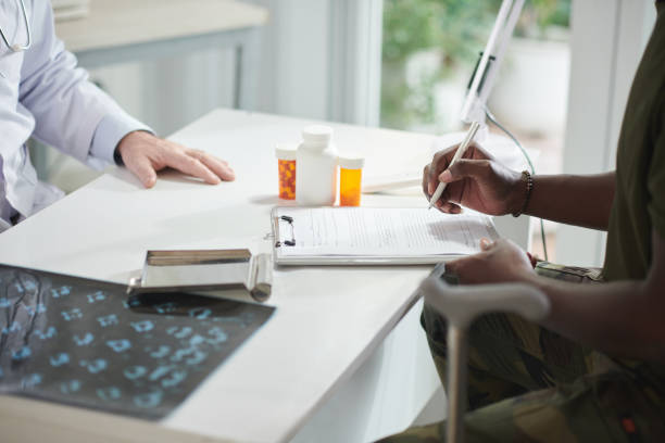 istock Black Man Filling Medical Form 1436796752