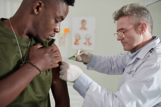 istock Medical Worker Injecting Vaccine 1436796774