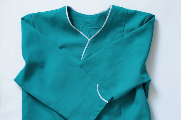 nurse work clothes in ukrainian hospital on white background close-up nurse work clothes in ukrainian hospital on white background Photo of scrubs being folded in a clean, eco-friendly workplace stock pictures, royalty-free photos & images