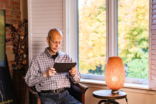 istock Senior man watching and listening broadcast on tablet 1436798677