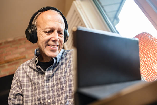 istock Senior man watching and listening broadcast on tablet 1436798791