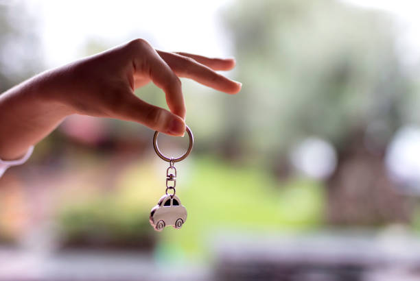 House keys and key chain isolated on white background. Copy space. Top view.