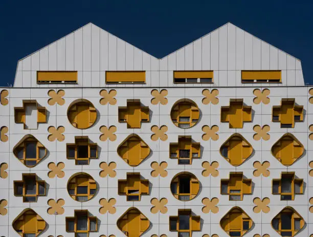 Photo of Paris, France - 10 01 2022: View of a white and yellow graphic wall of the facade of a building