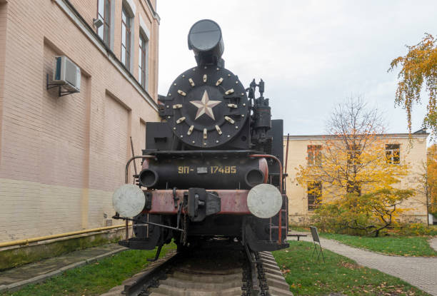 The Historical Train Park with train station and city hall in the background in donwtown Kingston, Ontario, on a cloudy summer day.