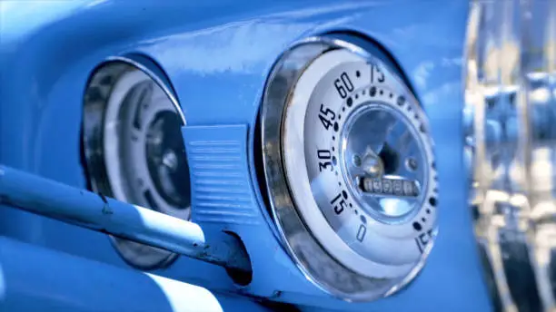 Photo of Close up Speedometer, dashboard. Action. Dashboard of a blue vintage American car