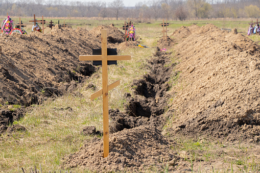new dug graves, grave cemetery for those infected by coronavirus, Ukraine Dnieper