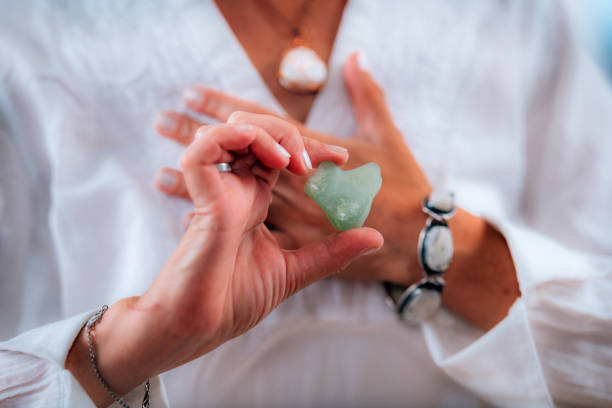 Heart Chakra Meditation with Green Aventurine Crystal Heart Chakra Meditation with Green Aventurine Crystal mantra stock pictures, royalty-free photos & images