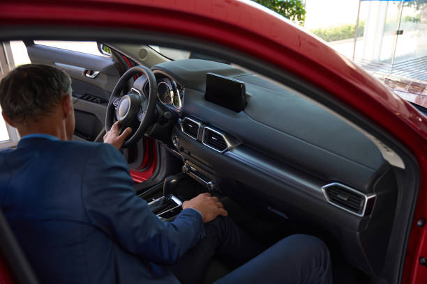istock Adult man examining red auto for buy 1436805940