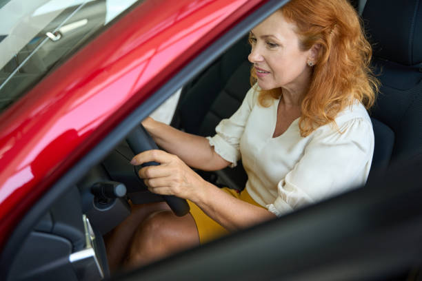 istock Woman examining a new car for purchase 1436805950