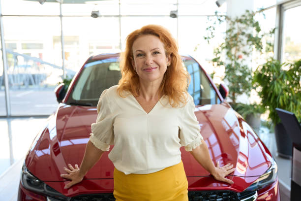 istock Smiling woman enjoying the gift in autosalon 1436806048