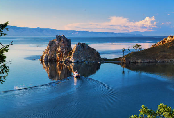 Burhan Cape and Shaman Rock of Olkhon Island on Baikal Lake Burhan Cape and Shaman Rock of Olkhon Island on Baikal Lake at sunset, Russia siberia summer stock pictures, royalty-free photos & images