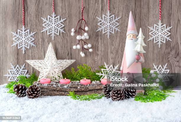 Advent Candles Santa Claus And A Christmas Star In The Snow Stock Photo - Download Image Now