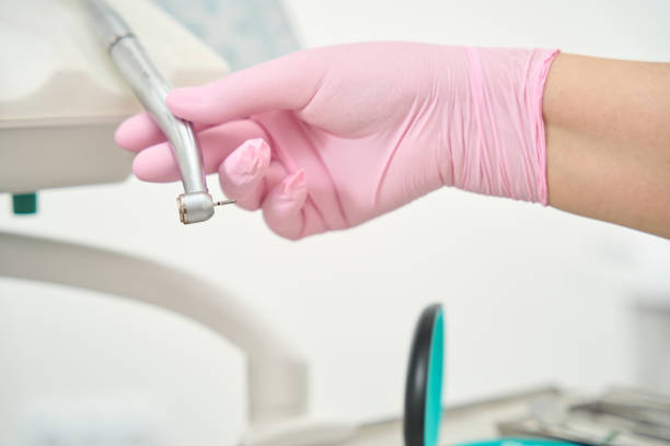 istock Doctor's hand in a protective glove holds a drill 1436814919
