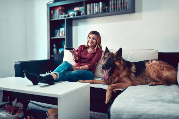 istock Female Changing Television Program According To Dog's Choice 1436825042