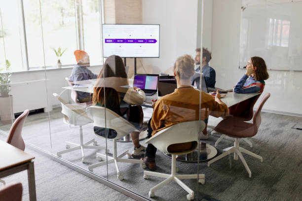istock Businessman giving a presentation in a boardroom 1436827831