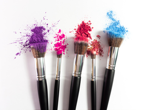 Creative concept beauty fashion photo of cosmetic product make up brushes kit with eyeshadows on white background.