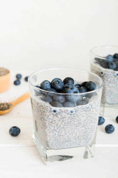 istock Healthy breakfast or morning with chia seeds vanilla pudding and blueberry berries on table background, vegetarian food, diet and health concept. Chia pudding with coconut milk and blueberry 1436834480