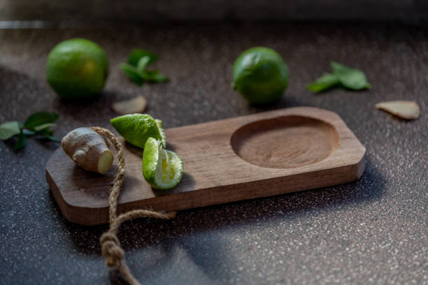 istock several limes, ginger and some lime wedges on a wooden board. 1436838128