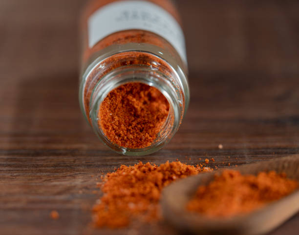 istock a glass jar with spices and a spoon with the same condiment. 1436841225