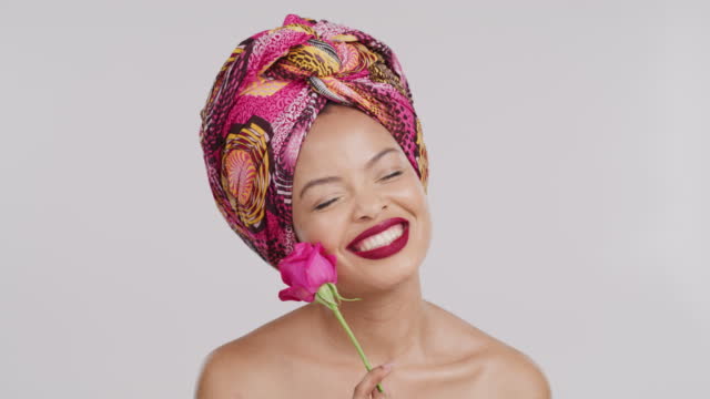 Rose, makeup and black woman with smile for love, fashion and flower against mockup studio background. Portrait of African girl with traditional clothes, cosmetics and flowers on mock up space