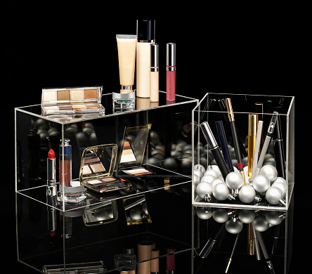 Transparent makeup organizer with numerous items.