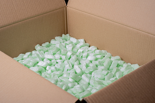 cardboard box filled with green foam protective granules. Online shopping concept.
Polystyrene Foam Packaging Filler Peanuts Cushioning Material