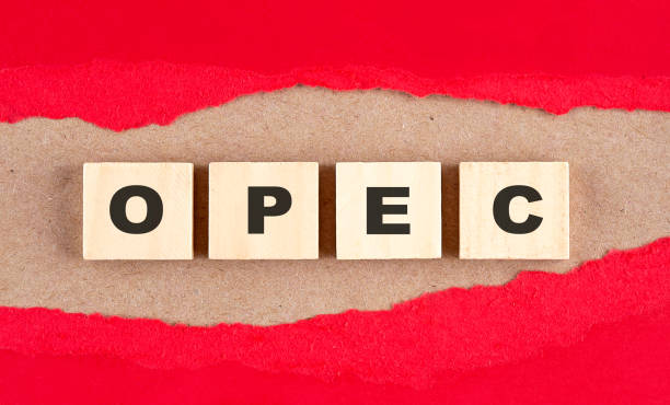 OPEC word on wooden cubes on red torn paper , financial concept background stock photo