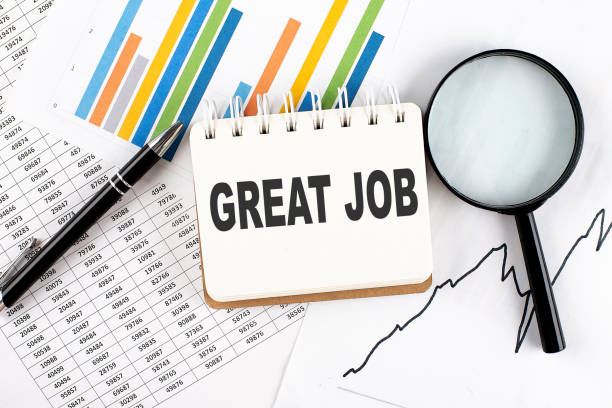 istock GREAT JOB text on notebook on the graph background with pen and magnifier 1436848979