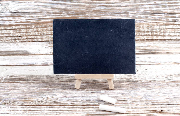 istock Blackboard menu with easel on wooden background, Copy space 1436849357