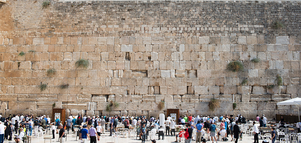 Jerusalem, Israel - November 15, 2022: View of the Wailing Wall with worshipers, the shrine of the Jewish religion in Jerusalem.