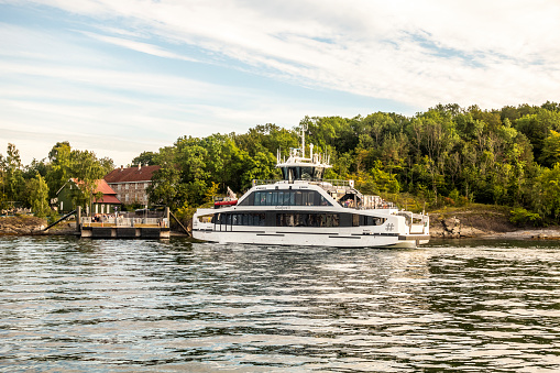 Electrical battery operated ferry arriving at the dock at Hovedoya Island in Oslo Fjord , 4k resolution
