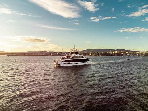 Electrical battery operated passenger ferry leaving Hovedoya Island Oslo Fjord  clear summer evening in Oslo, 4k resolution.  In the summer many tourists use it for a day trip.