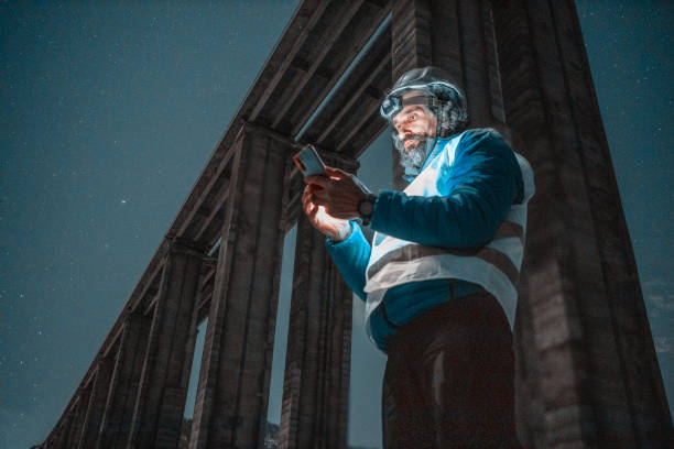 istock Road engineer working at night. Building new highways. 1436862271