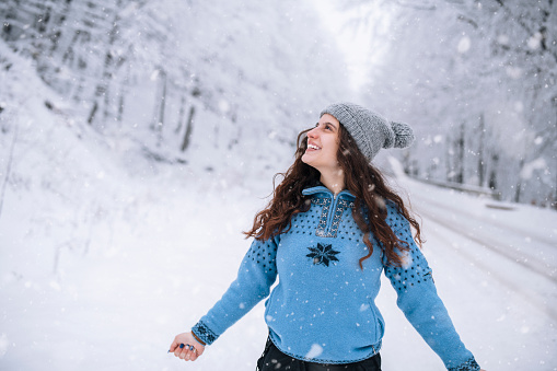 Happy young woman enjoying winter time.