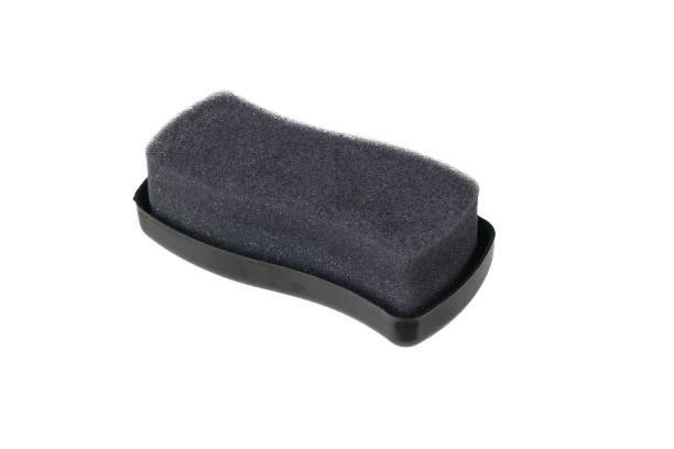 istock Black foam brush impregnated with cream isolated on a white background. 1436868734