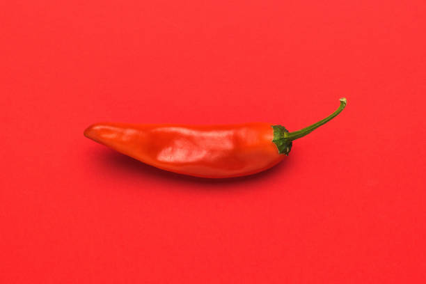 istock Bright red hot pepper on a bright red background. 1436868747