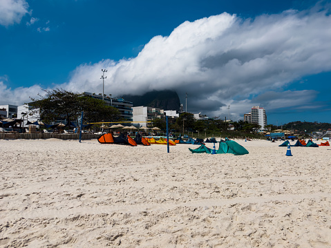 Barra da Tijuca beach, Rio de Janeiro, Brazil. Sunny day with blue sky and some clouds. Windsurfing practice.