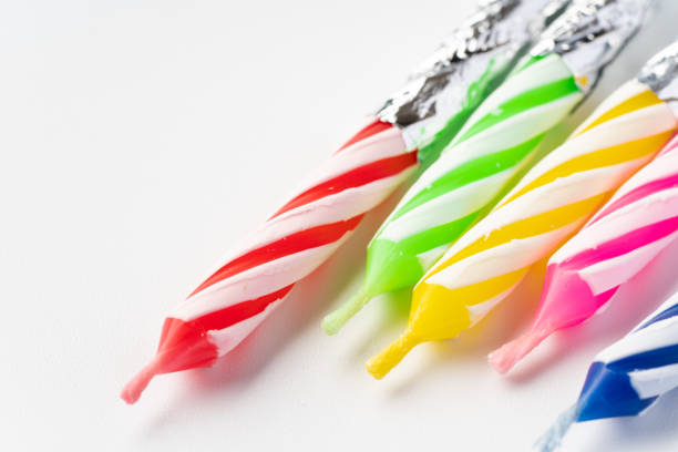 Colorful small candles on white background