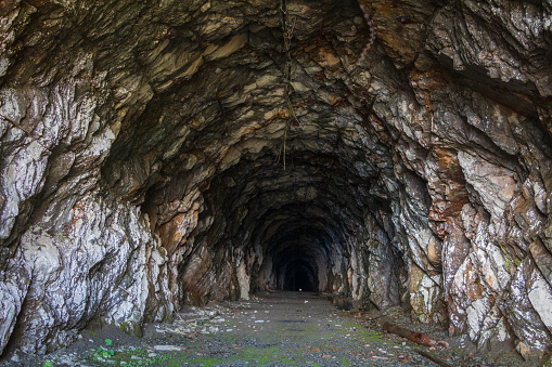 Old dark vaulted underground flooded sewer tunnel.